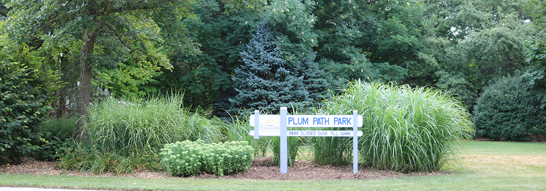 Plum Path park sign with trees