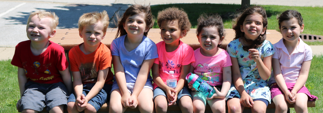 Happy kids on park bench